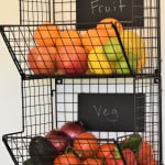 fruit and vegetable rack with food in it.