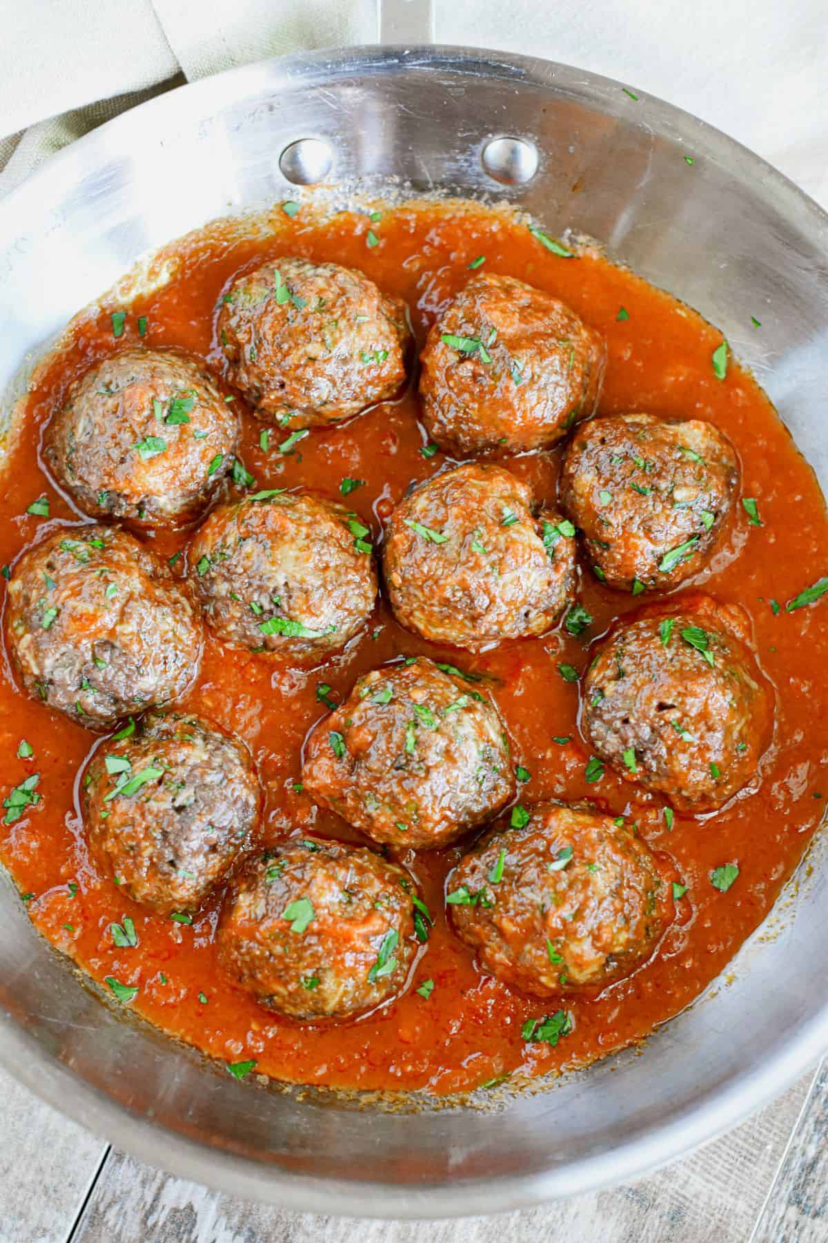 Impossible Burger Meatballs covered in sauce in a pan.