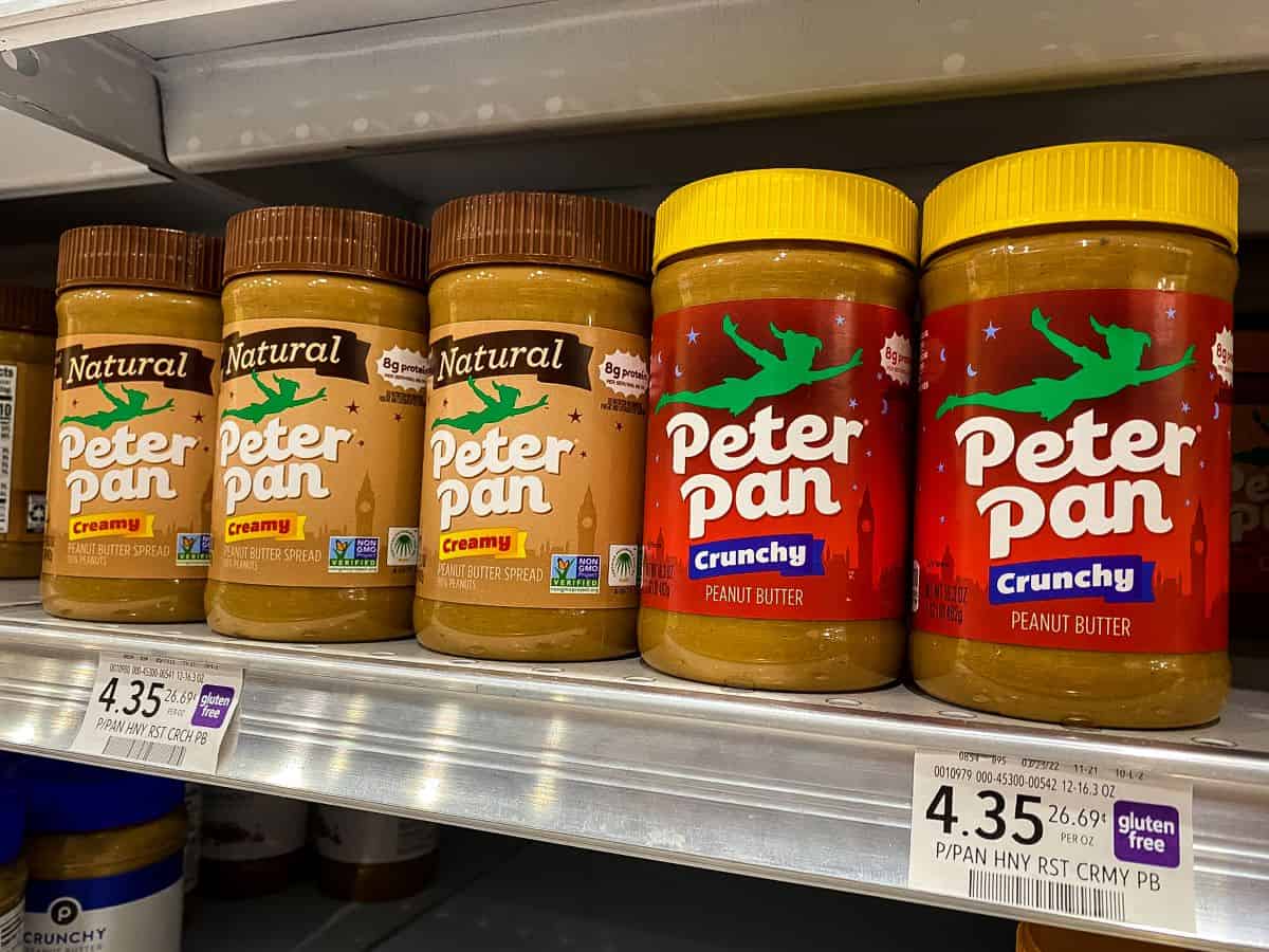 Peter Pan peanut butter on supermarket shelf.