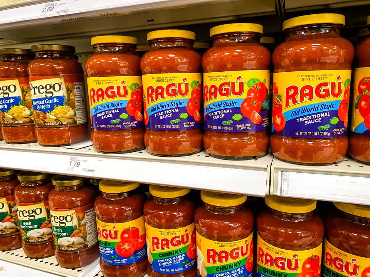 Jars of Ragu and Prego Tomato Sauce on supermarket shelves.