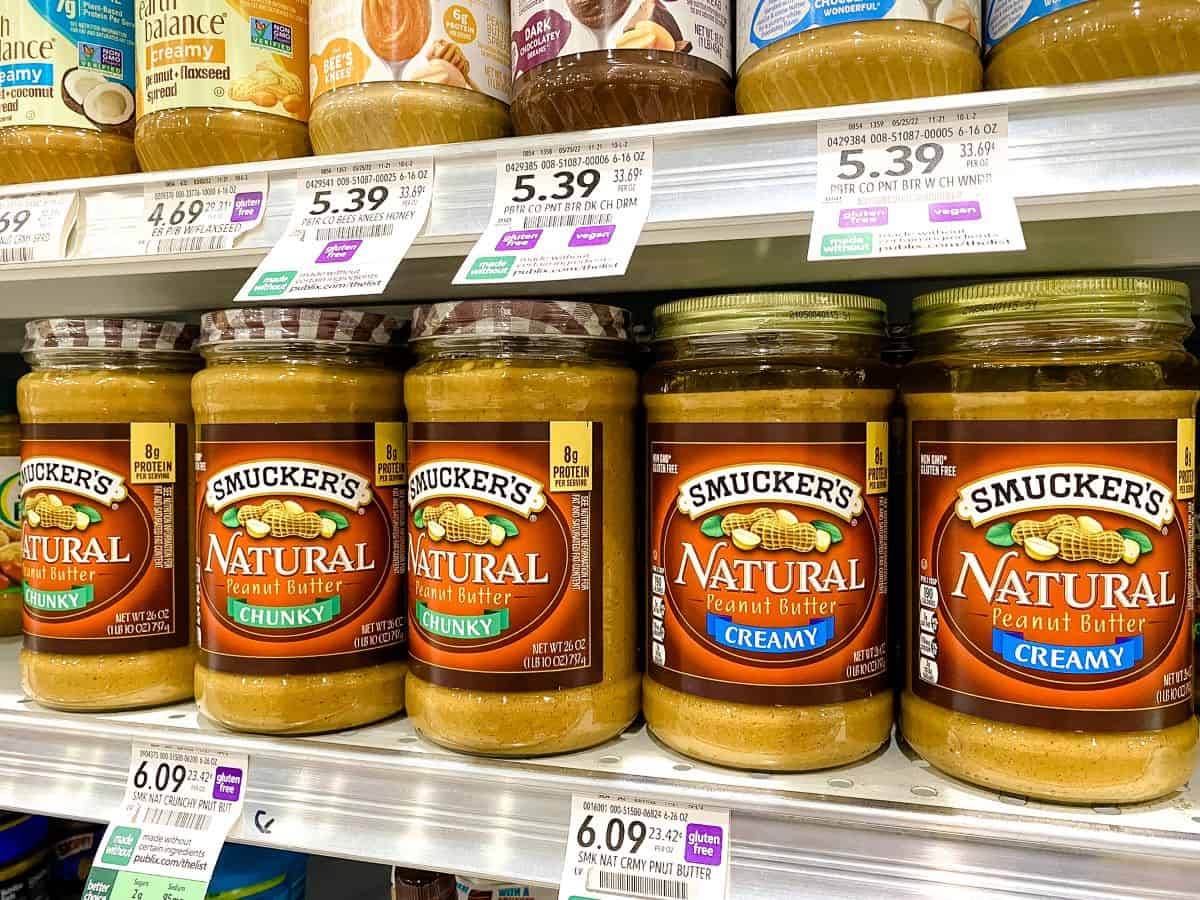 Smucker's natural peanut butter on supermarket shelf.