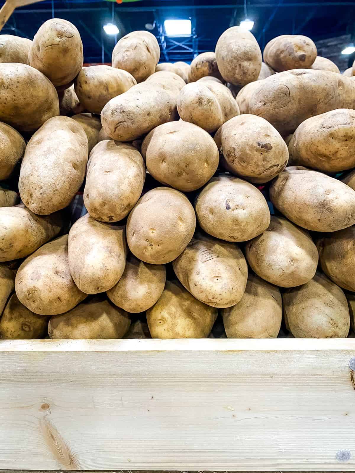 Stacks of potatoes at supermarket.