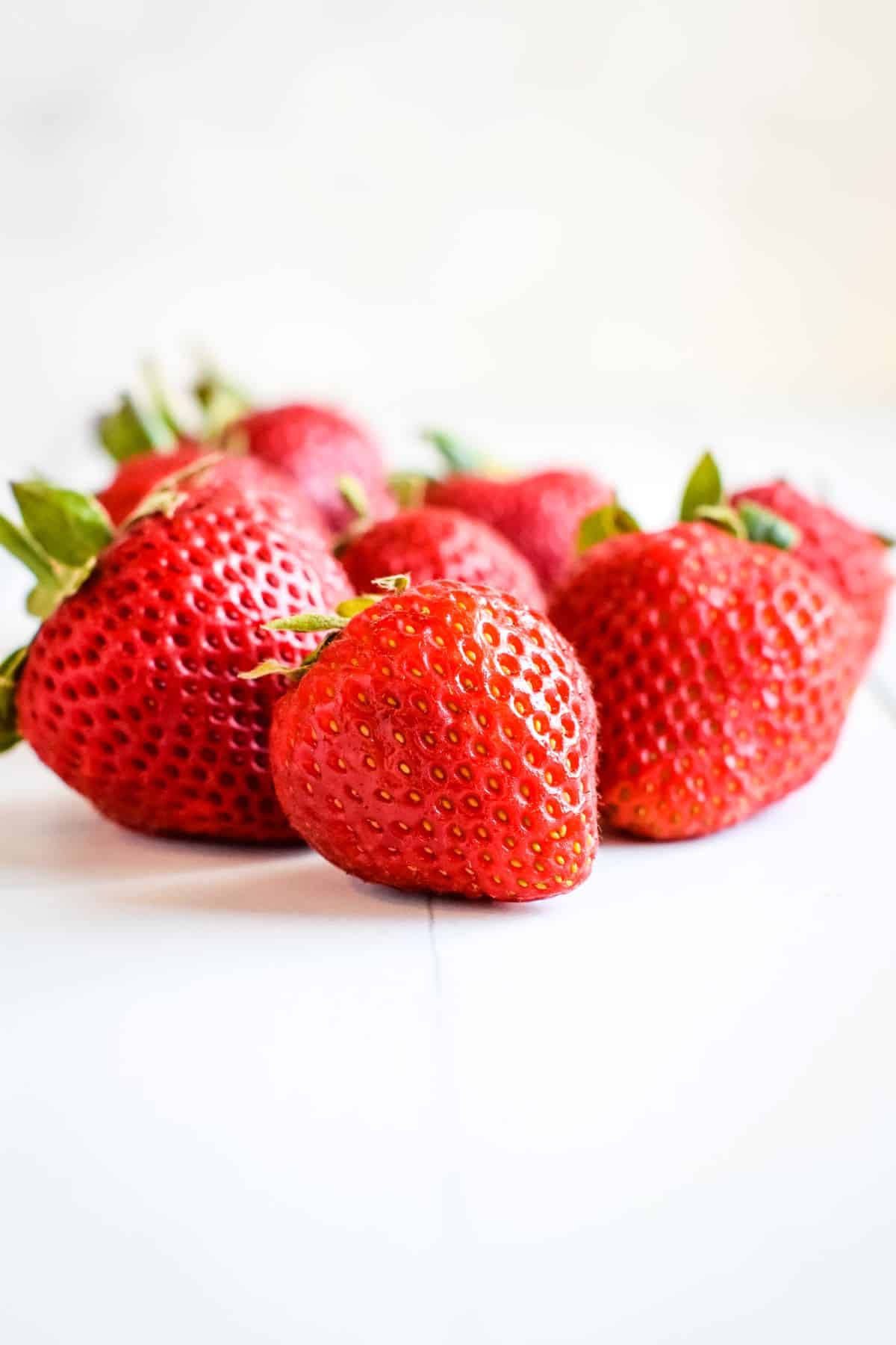 Strawberries spilled out on table.