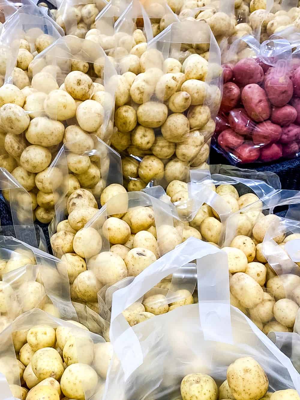 Bags of potatoes at supermarket.