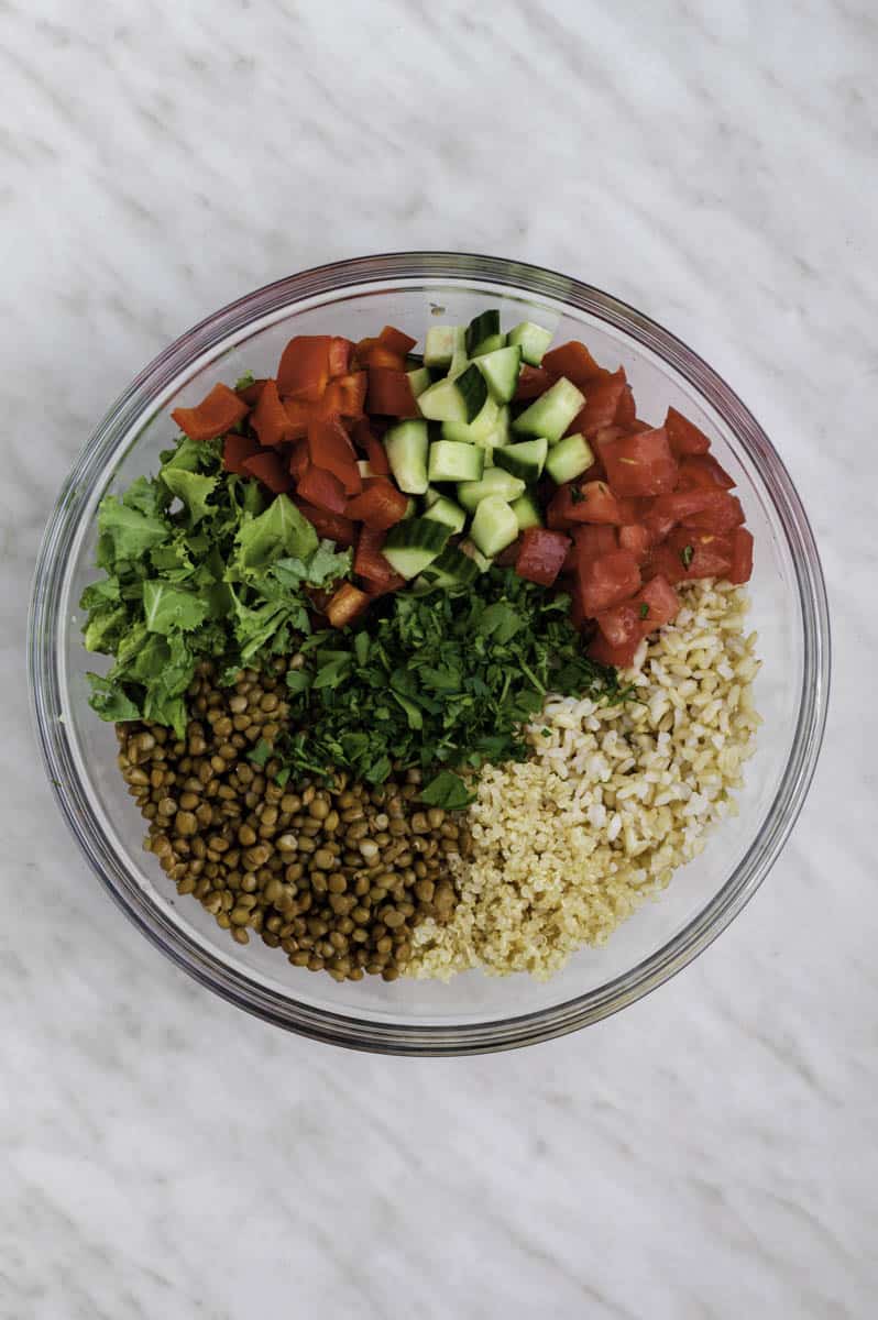 Salad ingredients in a glass mixing bowl.