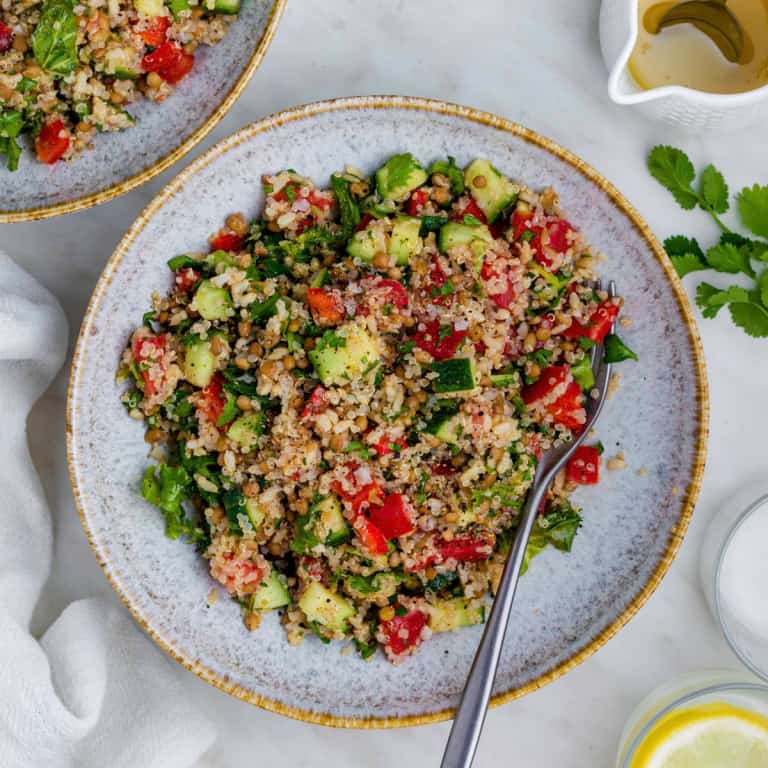 It's a copy of Costco's quinoa salad, served in a blue bowl with a fork on the right side of the bowl.
