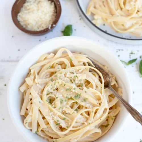 Instant Pot Fettuccini Alfredo in a bowl with a fork.