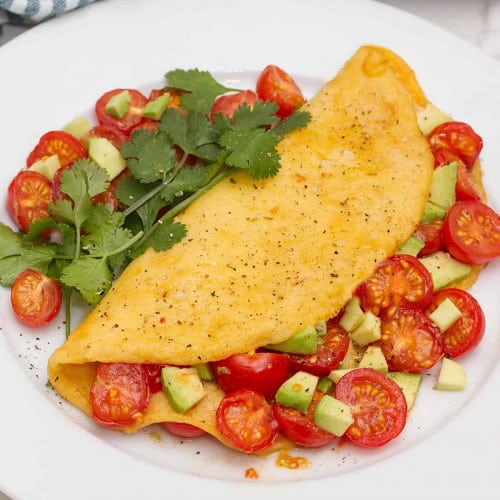 Just Egg Omelet with Roasted Cherry Tomatoes on a plate.