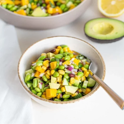 Edamame Mango Salad in a bowl with a spoon.