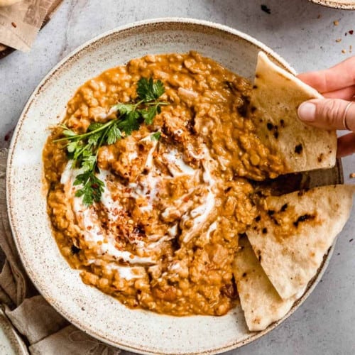 Red lentil dahl with coconut milk in a bowl.