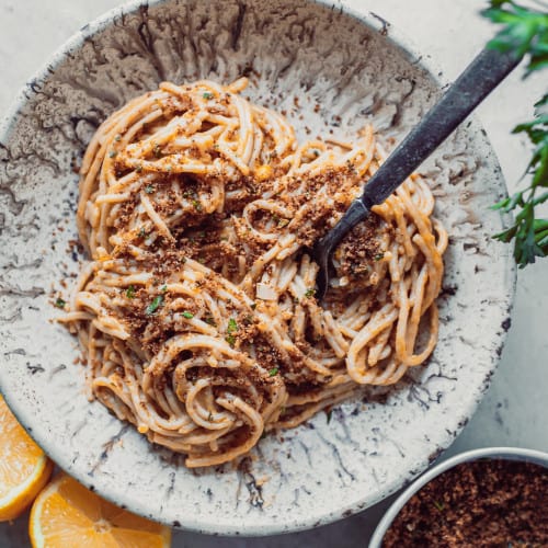 Lemon pasta in a bowl with a fork.