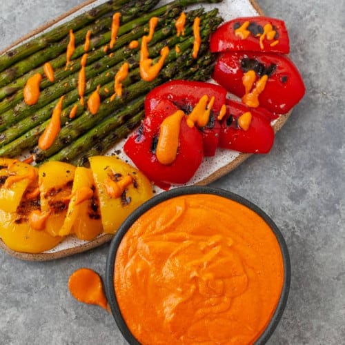 Grilled Summer Vegetables with Romesco Sauce on a dish.