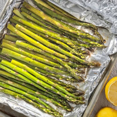Grilled Asparagus in Foil on a tray.