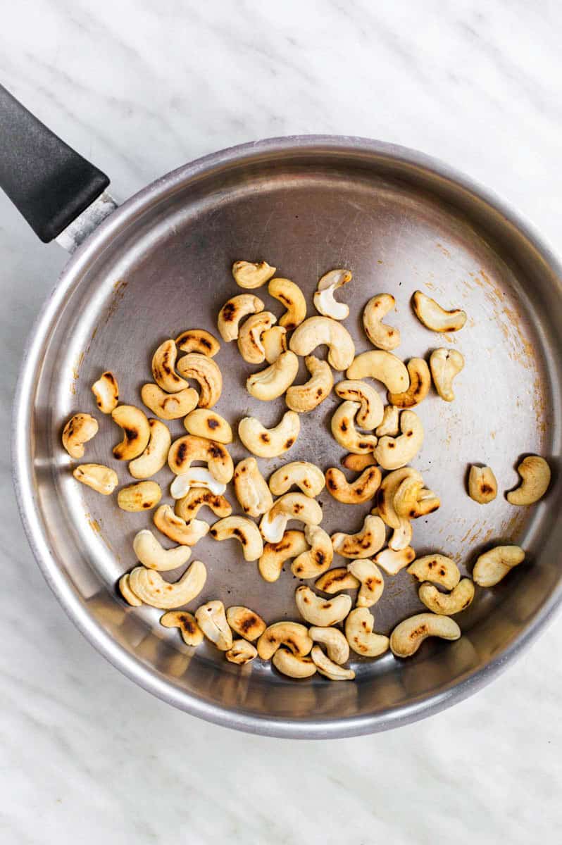 Toasting cashews in a dry skillet.