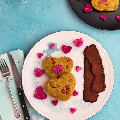 Omelet shaped like hearts on a plate.