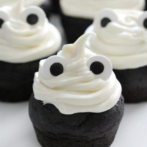 Gluten-Free Ghost Cupcakes on a white surface.