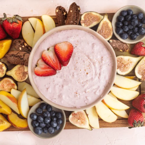 Vegan fruit dip in a bowl with fruit.