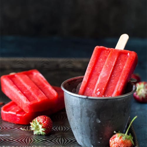 Strawberry Popsicles on a tray.