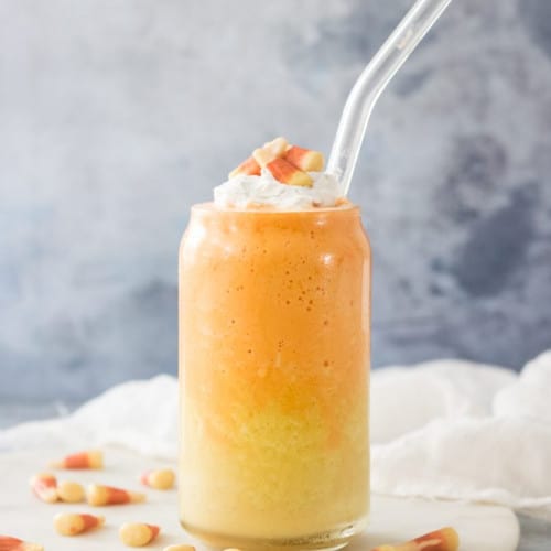 Dye-Free Vegan Candy Corn Smoothie in a glass with a straw.