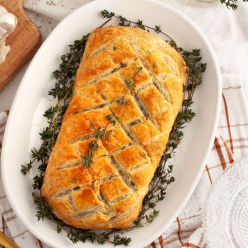 vegan mushroom wellington on a white serving dish.