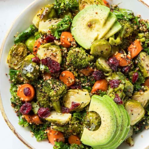 overhead of roasted vegetable, quinoa and kale salad in a serving bowl.