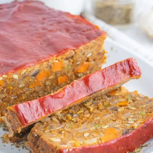 close-up of lentil loaf with two slices cut in the front.