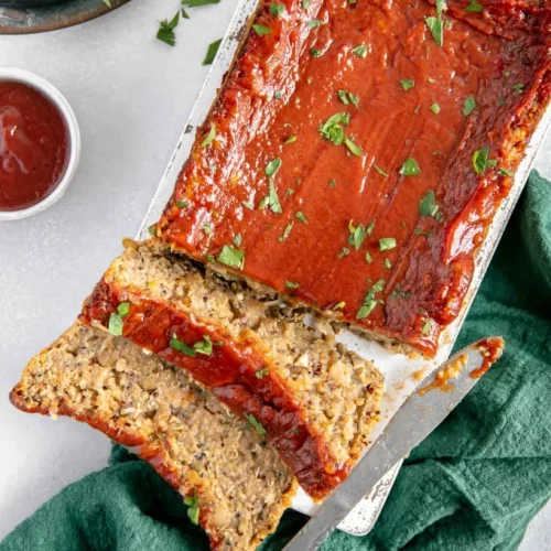 overhead of vegan meatloaf with two slices cut off and lying down in the front.
