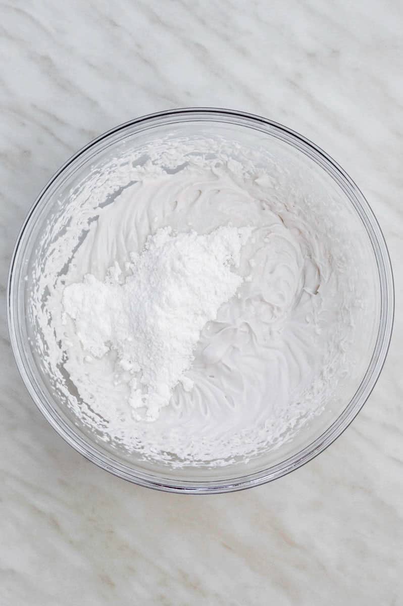 Adding powdered sugar to coconut cream.