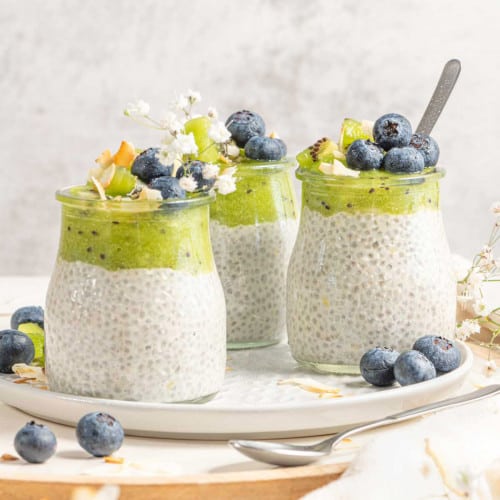 Vegan chia pudding topped with kiwi puree and blueberries.