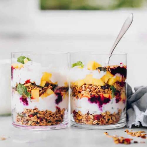 Breakfast parfaits layered with granola, fruit and cream.