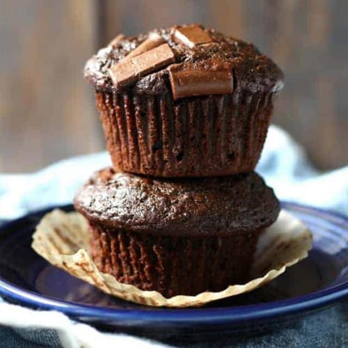 Two chocolate muffins stacked on top of each other.