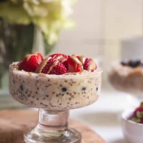 Vegan parfait in glass dish with berries on top.