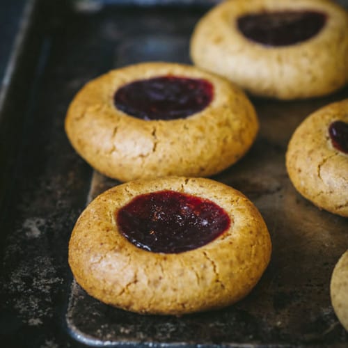 Thumbprint cookies on a baking tray.