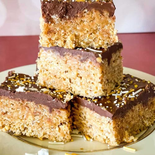 A snack of peanut butter and chocolate dessert bars on a plate.