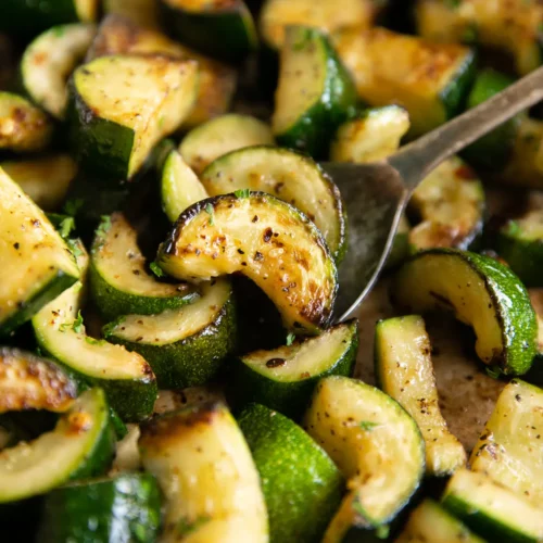 Sautéed Zucchini in a bowl and on a spoon.