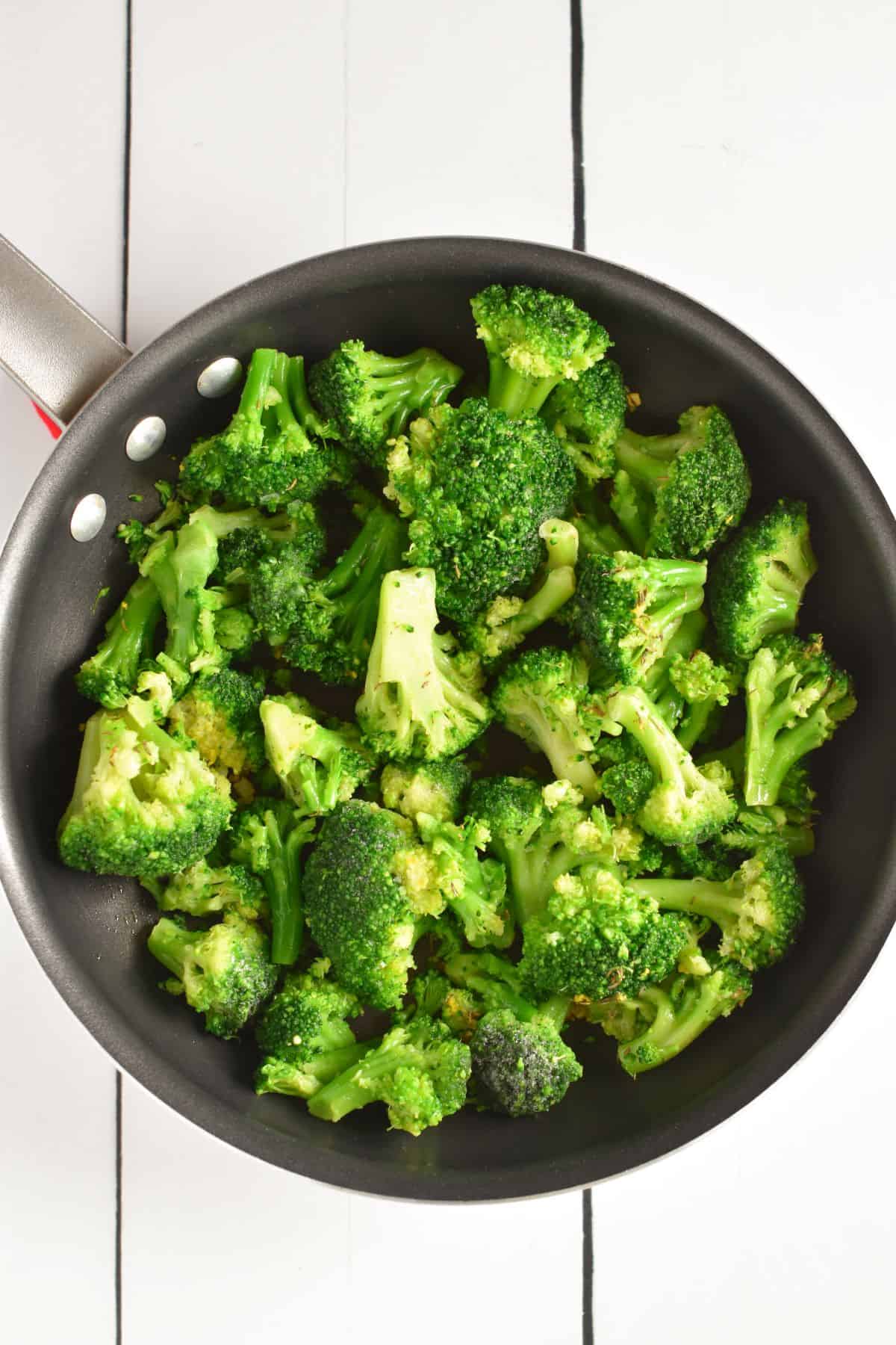 broccoli added to cooked garlic in nonstick pan.