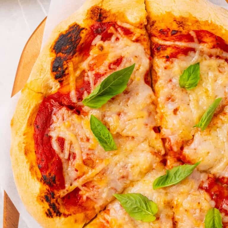 close up of vegan pizza topped with basil