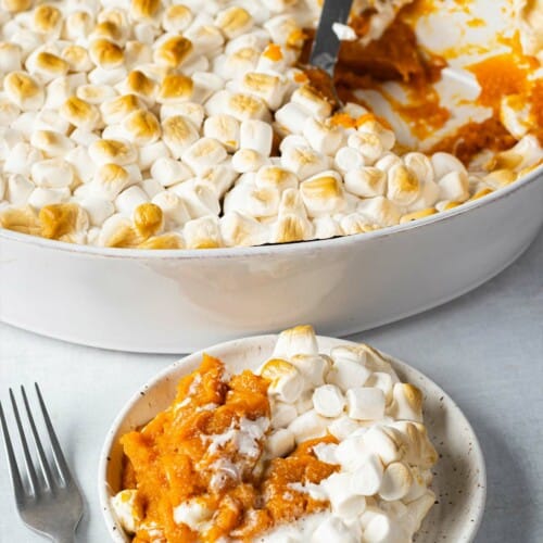 Sweet potato casserole with a serving on a plate.
