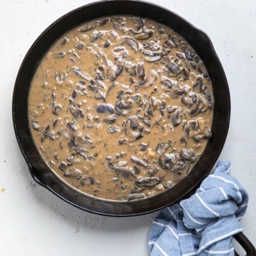 Mushroom sauce in a cast iron skillet on the table.