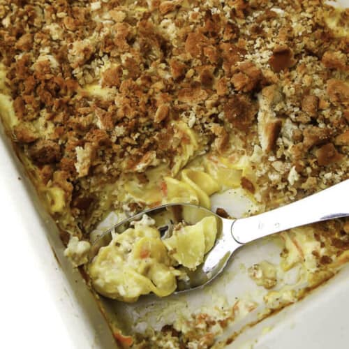 A top view of a vegan squash casserole with a spoon in it.