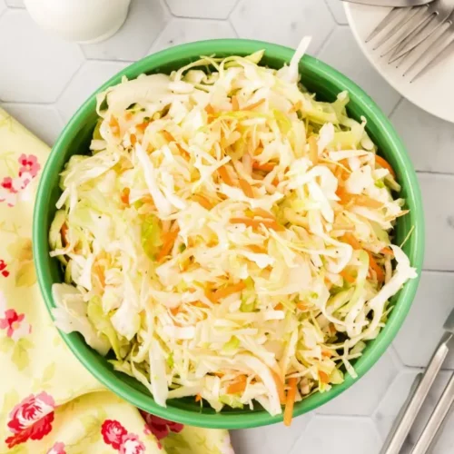 overhead of coleslaw in a green bowl.
