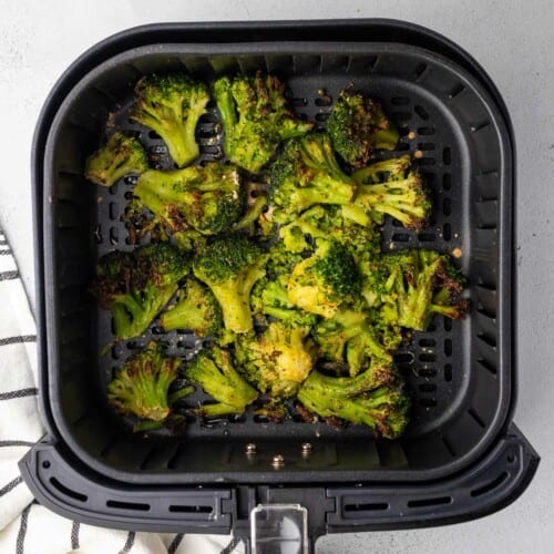 overhead of broccoli after cooking in air fryer basket.