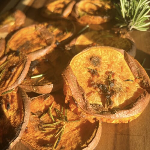 smashed sweet potatoes on a wooden board.