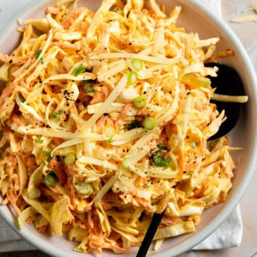 overhead of cheese coleslaw in a white bowl.