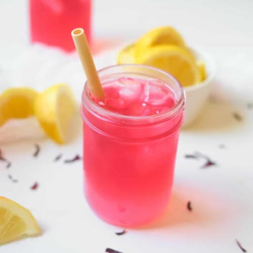 copycat starbucks passion tea lemonade in a jar with a straw.
