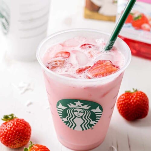 Starbucks Pink Drink copycat in a starbucks cup with a straw.