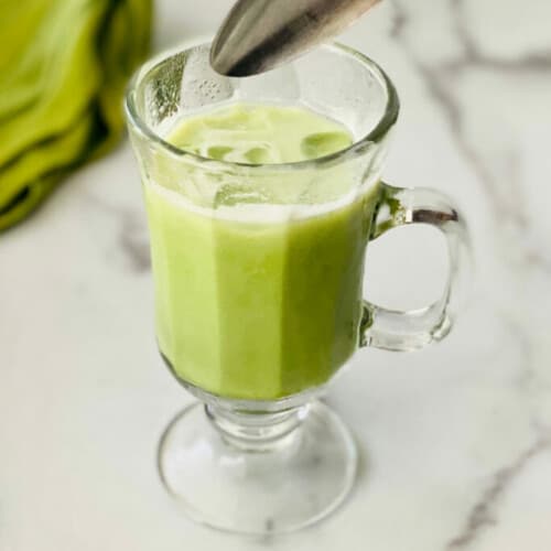 ICED MATCHA LATTE STARBUCKS COPYCAT in a glass with a spoon.