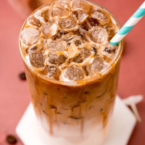 caramel drink on ice with a straw.