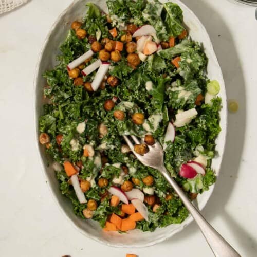 Overhead of kale salad in a white serving dish.