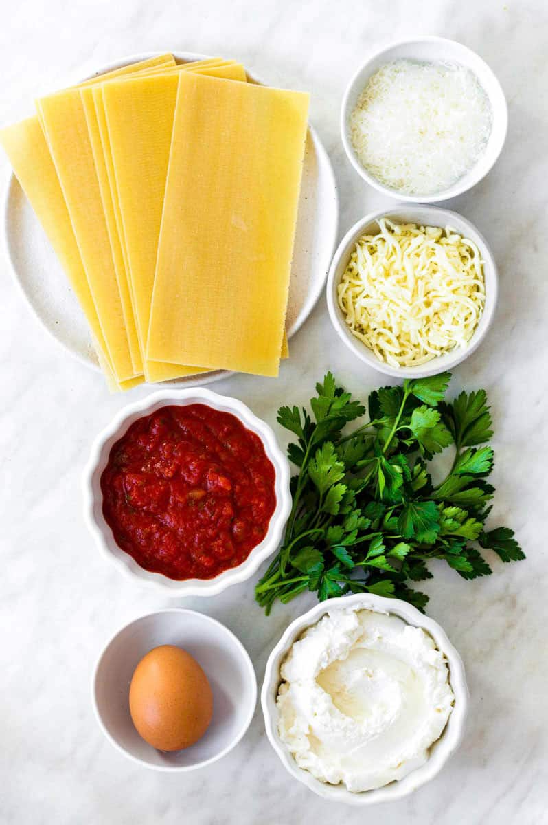 Gathered ingredients for making three cheese lasagna without meat.